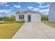 Charming single-story home with well-manicured lawn, pond view, and attached garage at 1011 Peridote Way, Ladson, SC 29456
