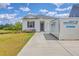 Inviting single-story home features a simple exterior, a small garden, and a moving container on the driveway at 1011 Peridote Way, Ladson, SC 29456