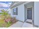 Close up of front door and entry way with a small porch and seating at 1011 Peridote Way, Ladson, SC 29456