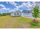 Charming single-story home with a well-maintained lawn, landscaping, and a moving container on the driveway at 1011 Peridote Way, Ladson, SC 29456