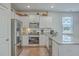 Stainless steel appliances, granite countertops, and light wood flooring in the kitchen at 1011 Peridote Way, Ladson, SC 29456