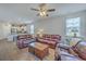 Bright living room showcasing hardwood floors, modern ceiling fan, and comfortable furniture at 1011 Peridote Way, Ladson, SC 29456