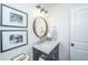 Stylish powder room featuring a modern vanity, round mirror, and decorative wall art at 1035 Planters Curve, Mount Pleasant, SC 29464