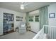 Bedroom with organized closet, bookshelves, chair, and a view of the window and crib at 1035 Planters Curve, Mount Pleasant, SC 29464