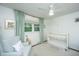 Bright Bedroom featuring a white crib, comfortable chair, and plenty of natural light at 1035 Planters Curve, Mount Pleasant, SC 29464