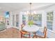 Charming dining area with white table, chandelier, and a large window, providing ample natural light and views at 1035 Planters Curve, Mount Pleasant, SC 29464