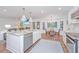 Bright and airy kitchen with stainless steel appliances and an adjacent living room at 1035 Planters Curve, Mount Pleasant, SC 29464