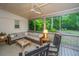 Relaxing screened porch with wicker furniture, ceiling fan, and lush backyard views at 1035 Planters Curve, Mount Pleasant, SC 29464