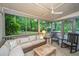 Covered porch features cozy seating, ceiling fan, and views of the outdoors at 1035 Planters Curve, Mount Pleasant, SC 29464