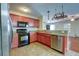 Modern kitchen with stainless steel appliances, granite counters, and warm cabinetry at 1039 Steelechase Ln, Hanahan, SC 29410