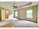 Spacious main bedroom featuring tray ceilings, neutral carpeting, and ample natural light from two large windows at 1039 Steelechase Ln, Hanahan, SC 29410