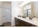 Bathroom with double sink vanity with stone countertop, dark wood cabinets, and decorative lighting at 104 Antilles Cir, Charleston, SC 29492