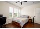 A bedroom with neutral gray bedding, wood floors, and bright windows with shutters at 104 Antilles Cir, Charleston, SC 29492