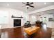 Open-concept living space with hardwood floors, a fireplace, and bright lighting at 104 Antilles Cir, Charleston, SC 29492