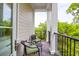 Cozy balcony with outdoor seating and black metal railings overlooking lush greenery at 108 Fairbanks Oak Aly # 401, Charleston, SC 29492