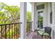Outdoor balcony with comfortable seating and iron railings offering scenic views of the surrounding trees at 108 Fairbanks Oak Aly # 401, Charleston, SC 29492