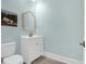 Cozy bathroom features light blue walls, white vanity, and decorative framed art at 108 Fairbanks Oak Aly # 401, Charleston, SC 29492