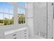 Bright, airy bathroom with marble shower, sleek vanity, and large windows offering great views at 108 Fairbanks Oak Aly # 401, Charleston, SC 29492