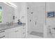 All-white bathroom featuring marble floors and shower with black accents, vanity, and nature-filled window at 108 Fairbanks Oak Aly # 401, Charleston, SC 29492
