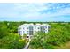 Elevated exterior view with green surrounding the property, providing a private and peaceful setting at 108 Fairbanks Oak Aly # 401, Charleston, SC 29492
