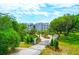 Stunning exterior view of modern condos behind a gated entrance, surrounded by beautifully landscaped grounds at 108 Fairbanks Oak Aly # 401, Charleston, SC 29492