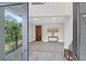 Welcoming foyer with a dark wood door, console table, and view to outdoor balcony at 108 Fairbanks Oak Aly # 401, Charleston, SC 29492