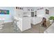 Open-concept kitchen with white cabinets, quartz countertops, and counter seating at 108 Fairbanks Oak Aly # 401, Charleston, SC 29492