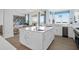 Bright kitchen features an island with white cabinets, granite countertops, and modern stainless steel appliances at 108 Fairbanks Oak Aly # 401, Charleston, SC 29492