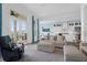 Comfortable living space with French doors leading to the porch, kitchen access, and comfortable seating at 108 Fairbanks Oak Aly # 401, Charleston, SC 29492