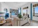 Elegant living area with large windows, fireplace, comfortable seating, and designer touches at 108 Fairbanks Oak Aly # 401, Charleston, SC 29492