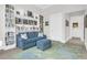 Comfortable office space with blue sofa, bookshelf, decorative rug and view into hall at 108 Fairbanks Oak Aly # 401, Charleston, SC 29492