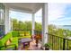 Covered porch with comfortable seating and views of the surrounding greenery at 108 Fairbanks Oak Aly # 401, Charleston, SC 29492
