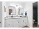 Bright bathroom with double sink vanity, granite countertop, black fixtures, and decorative framed mirrors at 109 New Spring Ct, Summerville, SC 29485