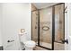 Modern bathroom featuring a glass-enclosed shower with tile, and a white toilet on wood floors at 109 New Spring Ct, Summerville, SC 29485