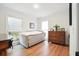 Bedroom featuring an antique dresser, natural light from two windows, and hardwood floors at 109 New Spring Ct, Summerville, SC 29485
