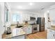 Well-lit kitchen with granite countertops, stainless steel appliances, and white cabinetry at 109 New Spring Ct, Summerville, SC 29485