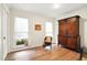 Bright room with two windows, wood floors, an antique armoire, and a wicker chair at 109 New Spring Ct, Summerville, SC 29485