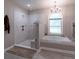 Bright bathroom featuring a shower, soaking tub, and a window with a view at 111 Coltsgate Ct, Summerville, SC 29485