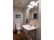 Powder room with wood floors, stainless steel fixtures, a white sink and toilet at 111 Coltsgate Ct, Summerville, SC 29485