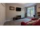 Bright bedroom with a window, carpeted floor, closet, television and exercise equipment at 111 Coltsgate Ct, Summerville, SC 29485