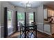 Cozy breakfast nook featuring natural light, a dark table, and views of the landscaped backyard at 111 Coltsgate Ct, Summerville, SC 29485