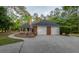 Attached two-car garage with extended driveway and side entrance, surrounded by lush landscaping at 111 Coltsgate Ct, Summerville, SC 29485