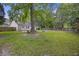 A serene backyard with lush greenery, trees, and a cozy fire pit for relaxation at 111 Macfarren Ln, Summerville, SC 29485