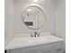 Updated bathroom featuring gray vanity, stone countertop, and round mirror at 111 Macfarren Ln, Summerville, SC 29485