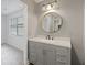 Bathroom with modern gray vanity, stone countertop, round mirror at 111 Macfarren Ln, Summerville, SC 29485