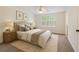 Cozy bedroom with neutral colors, plush carpet, and a large window offering ample natural light at 111 Macfarren Ln, Summerville, SC 29485