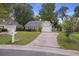 Lovely single-Gathering home with a driveway, garage, and a lush green lawn, creating a welcoming curb appeal at 111 Macfarren Ln, Summerville, SC 29485