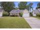 Cozy home with a brick accent, blue shutters, one-car garage and well-kept lawn in a quaint neighborhood at 111 Macfarren Ln, Summerville, SC 29485
