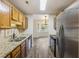 Galley kitchen offering stainless steel appliances, granite countertops, and direct access to the dining area at 111 Macfarren Ln, Summerville, SC 29485