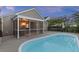 A home's backyard features an in-ground pool, a screened-in porch, a hammock, and beautiful landscaping and lawn at 1110 Flyway Rd, Summerville, SC 29483